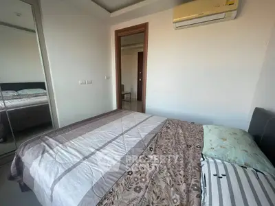 Cozy bedroom with air conditioning and mirrored closet doors, perfect for comfortable living.
