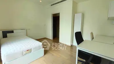 Spacious bedroom with modern furniture and wooden flooring