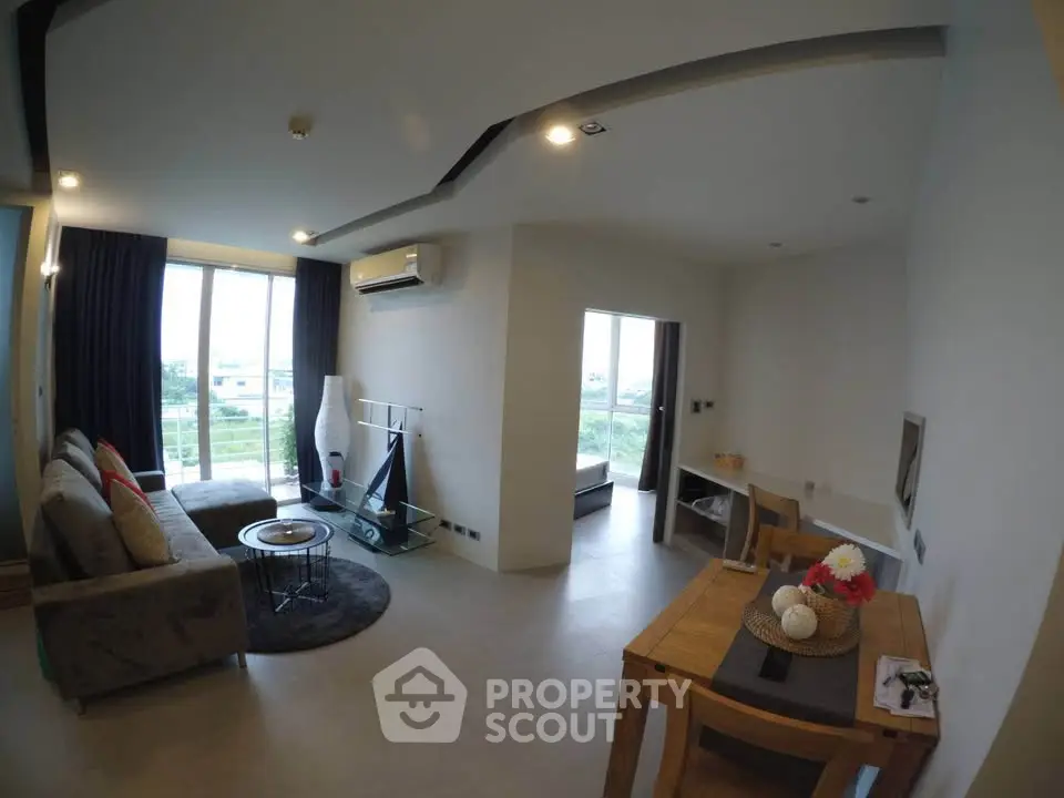 Spacious modern living room with large windows and stylish decor