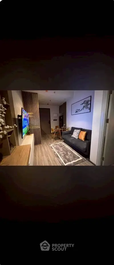 Modern living room with sleek design, cozy sofa, and wall-mounted TV in stylish apartment.
