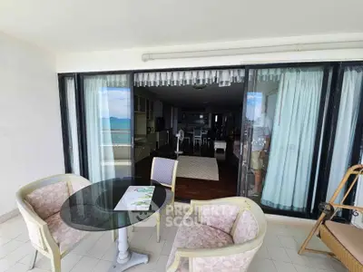 Spacious balcony with ocean view and elegant indoor-outdoor living area.