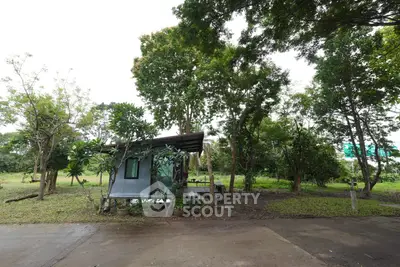 Charming small house surrounded by lush greenery and trees, perfect for nature lovers seeking tranquility.