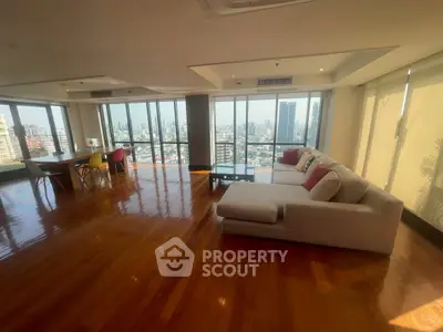 Spacious living room with panoramic city views and modern furnishings