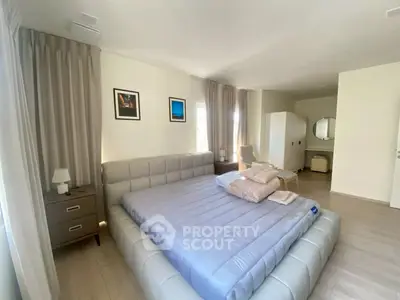 Spacious modern bedroom with elegant decor and natural light