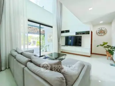 Spacious modern living room with large windows and elegant decor