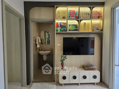Modern living room with built-in TV unit and open bathroom view