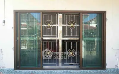 Stylish window with decorative metal grille in modern home exterior