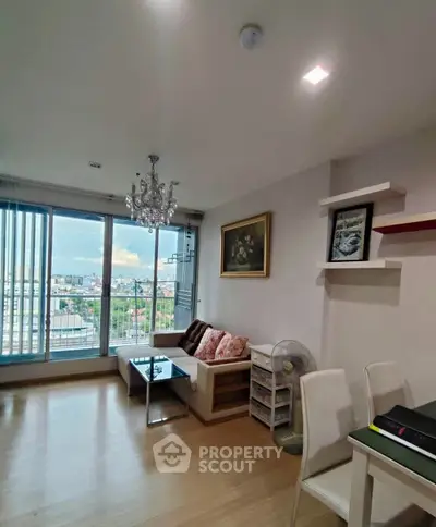 Spacious living room with city view and elegant chandelier