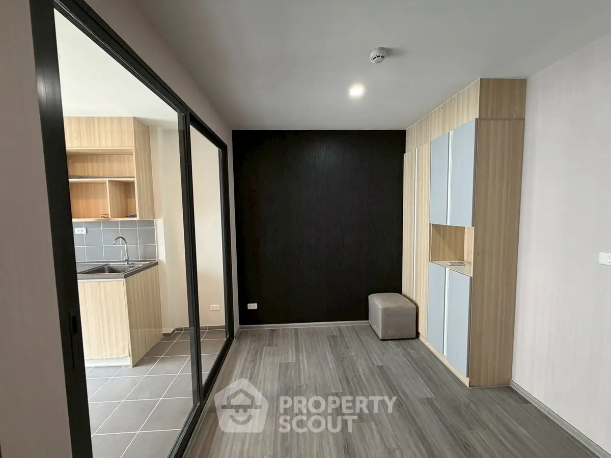 Modern apartment interior with open kitchen and stylish wood paneling