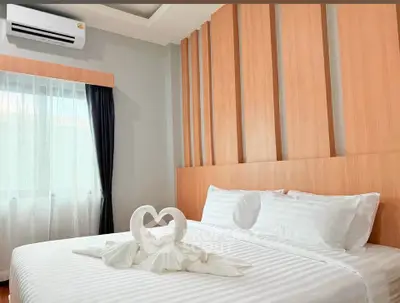 Elegant bedroom with stylish wooden paneling and cozy bedding