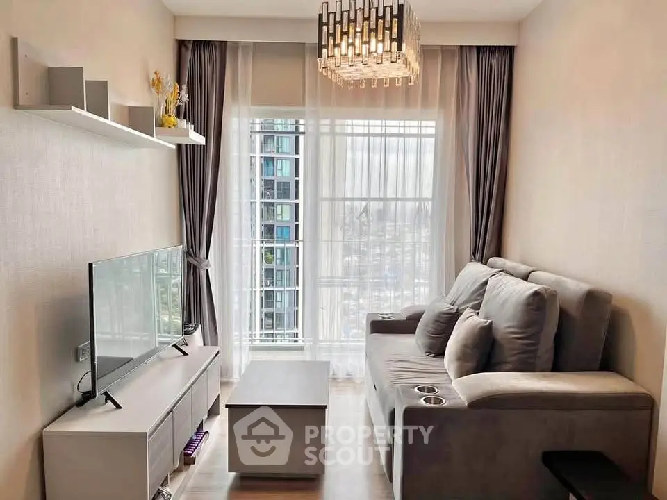 Modern living room with sleek furniture and large window offering city view