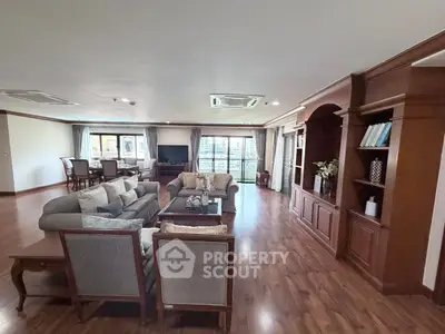 Spacious living room with elegant wooden flooring and classic furniture