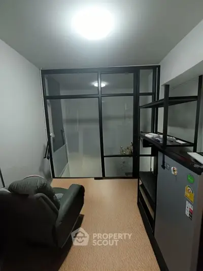 Cozy small living room with modern furniture and glass partition