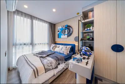 Modern bedroom with stylish decor and ample natural light, featuring a cozy bed and sleek storage solutions.