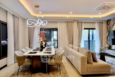 Luxurious modern living room with elegant dining area and stylish lighting, perfect for entertaining guests.