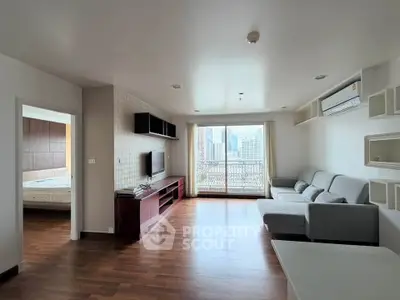 Spacious modern living room with city view and elegant wooden flooring
