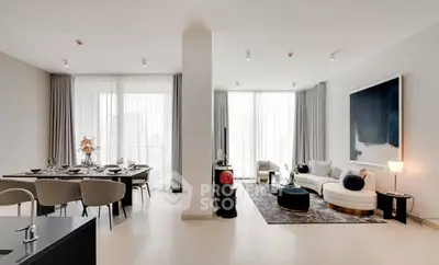 Spacious modern living room with elegant dining area and large windows.