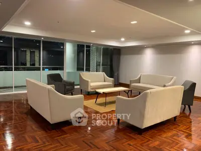 Spacious modern living room with elegant seating and parquet flooring, perfect for entertaining guests.