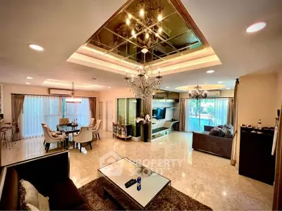 Luxurious open-plan living room with elegant chandelier and modern decor