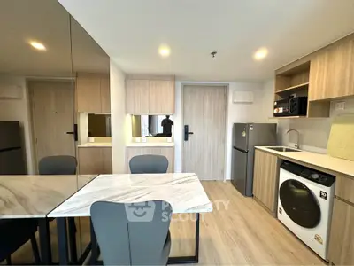 Modern kitchen with sleek appliances and stylish dining area