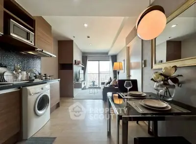 Modern open-plan kitchen and living room with stylish decor and natural light.