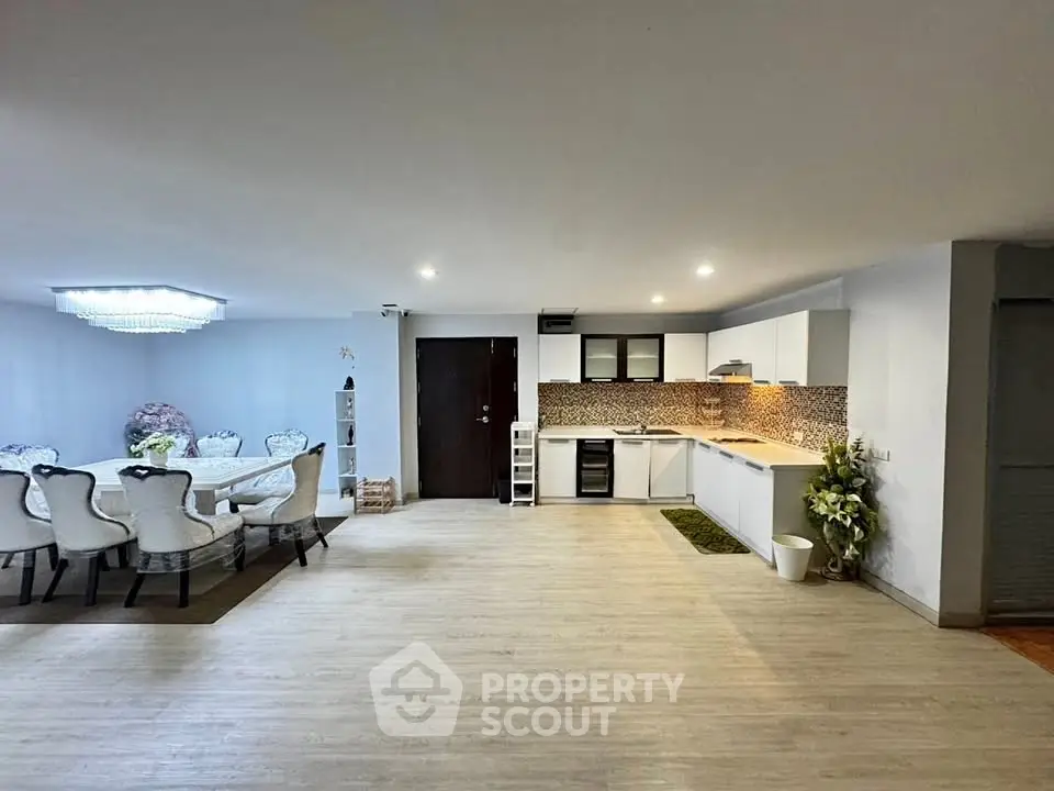 Spacious open-plan living room with modern kitchen and elegant dining area