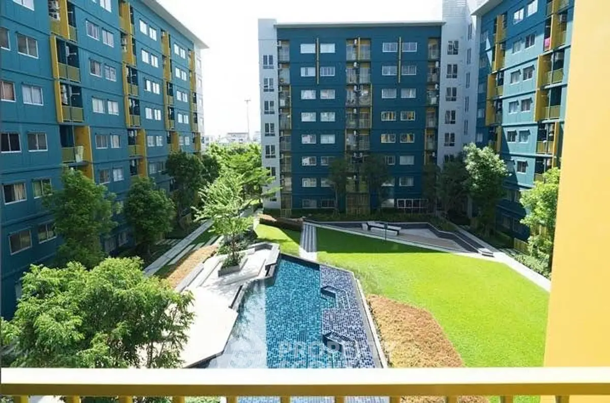 Modern apartment complex with lush garden and pool view