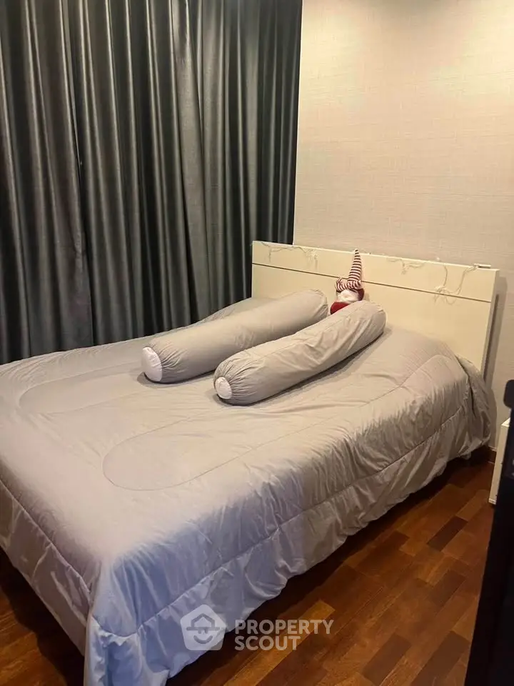 Cozy bedroom with elegant curtains and stylish bedding, perfect for relaxation and comfort.