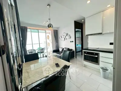Modern open-plan kitchen and living area with sleek design and balcony view.