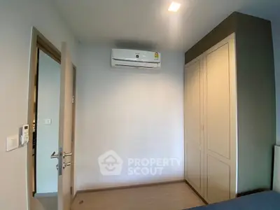 Modern bedroom with air conditioning and built-in wardrobe in a stylish apartment.