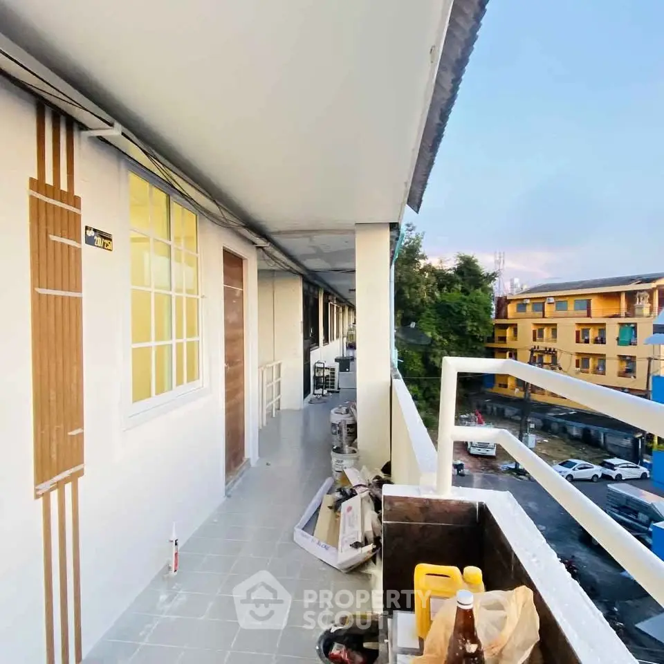 Spacious balcony with modern railing overlooking vibrant neighborhood