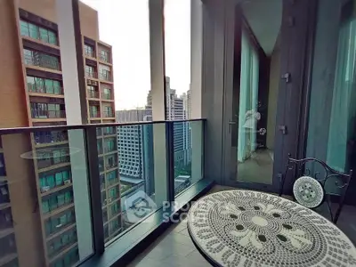 Modern high-rise balcony with city view and stylish outdoor furniture.