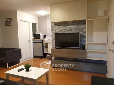 Modern living room with stylish TV unit and cozy seating area, perfect for relaxation and entertainment.