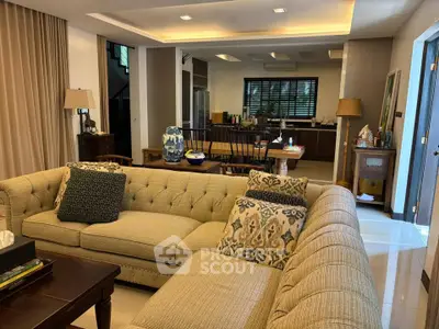Spacious living room with elegant decor and open kitchen layout, perfect for modern family living.