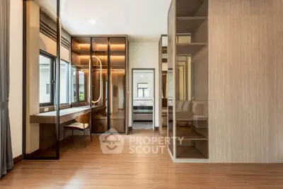 Spacious modern bedroom with elegant wooden flooring and built-in storage solutions.