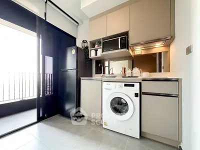 Modern kitchen with sleek appliances and balcony view