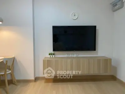 Modern living room with wall-mounted TV and minimalist decor