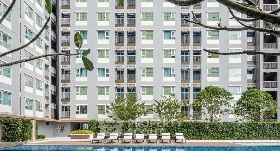 Modern apartment building with pool and lush greenery, ideal for urban living.