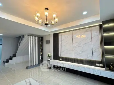 Luxurious modern living room with elegant chandelier and marble accents