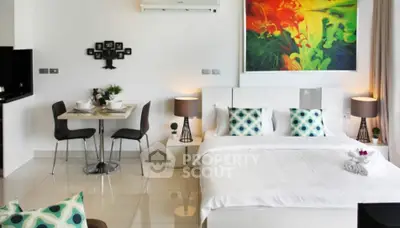 Modern bedroom with stylish decor and dining area in open-plan layout.