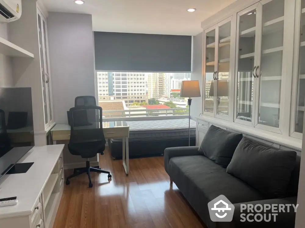 Modern study room with city view, featuring sleek furniture and ample natural light.