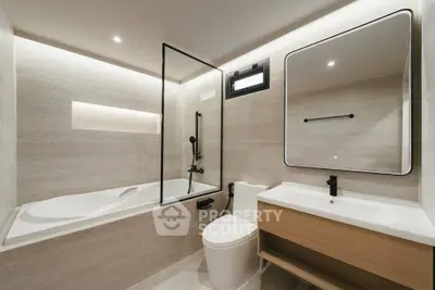 Modern bathroom with sleek design, featuring a bathtub and stylish fixtures.