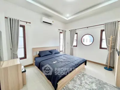 Spacious modern bedroom with stylish decor and natural light