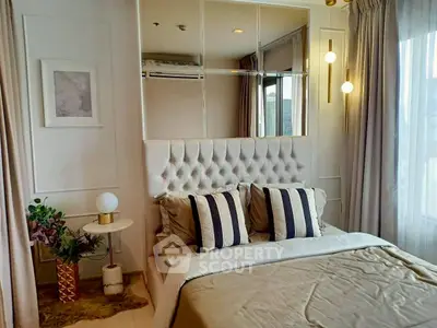Luxurious bedroom with elegant decor and large windows offering natural light.
