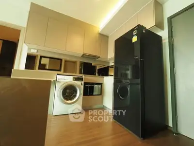 Modern kitchen with sleek appliances and wooden flooring