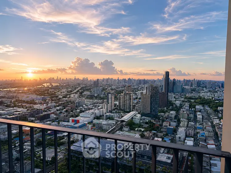 Stunning cityscape view from a high-rise balcony at sunset, showcasing urban skyline and vibrant sky.