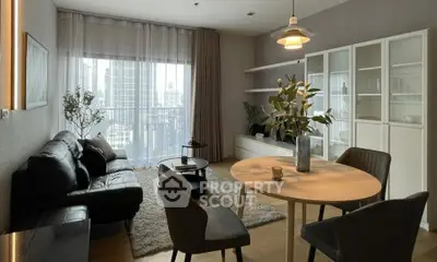 Modern living room with city view, stylish furniture, and natural light.