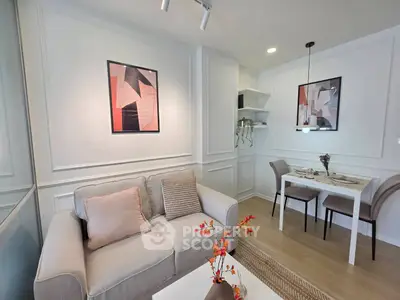 Chic modern living room with cozy sofa and stylish dining area in open layout apartment.