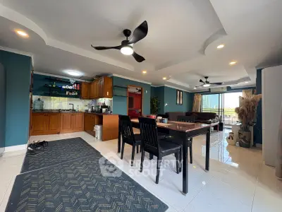 Spacious open-plan living and dining area with modern kitchen and stylish decor.