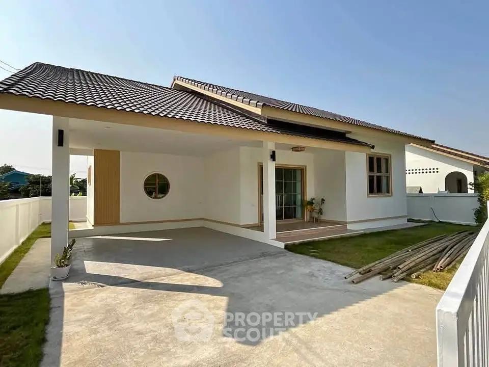 Charming single-story home with spacious driveway and modern design.